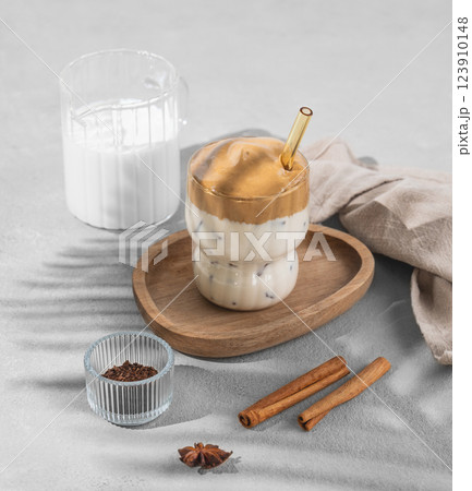 Korean whipped drink Dalgona coffee  on a woden plate on a concrete background with spice  Korean whipped drink Dalgona coffee  on a woden plate on a concrete background with spice  123910148