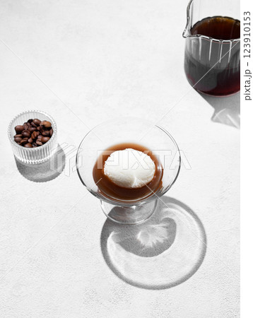 Affogato coffee with a scoop of vanilla ice cream and espresso in a glass on a light background Affogato coffee with a scoop of vanilla ice cream and espresso in a glass on a light background 123910153