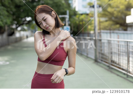 women red sportswear standing problem neck, shoulder and back painful after exercise. female bone injuries pain. discomfort sprain orthopedic. 123910178