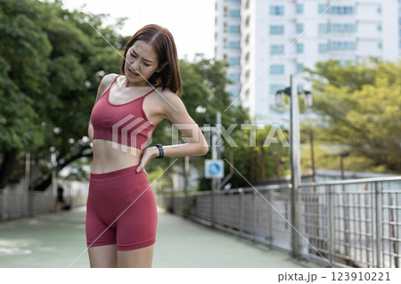 women red sportswear standing problem backache painful after exercise. female lower back pain. discomfort sprain orthopedic. 123910221