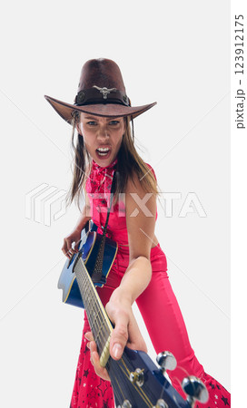 Energetic woman, musician in cowboy hat playing blue guitar with fierce passion against white background. 123912175
