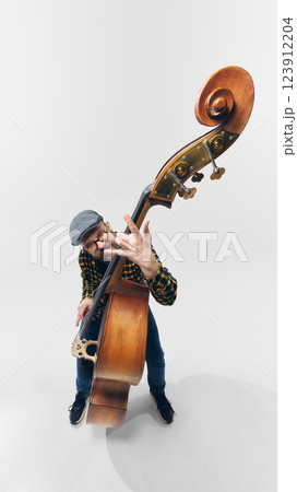 Rockstar bassist bending strings with intensity, fully immersed in rebellious and powerful musical moment. Rockstar bassist bending strings with intensity, fully immersed in rebellious and powerful musical moment. 123912204