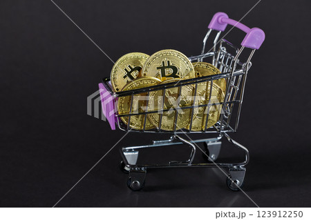 shopping cart filled with bitcoin coins on black background, concept of cryptocurrency investment and digital currency trade shopping cart filled with bitcoin coins on black background, concept of cryptocurrency investment and digital currency trade 123912250