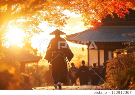 Samurai walking through a japanese village at sunset during autumn 123913367