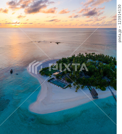 Aerial views of Velavaru Island at sunset in Maldives 123914130