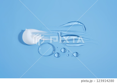 Drops and smears of cosmetic products on a blue background. 123914280