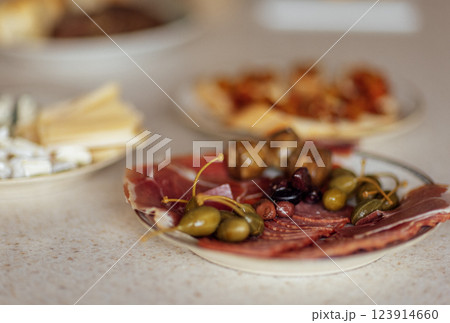 Close-up of plates with various delicious snacks on a white marble table. 123914660