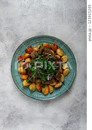 kuyrdak, roast offal with potatoes and fresh herbs, homemade in Kazakh, no people, 123915285