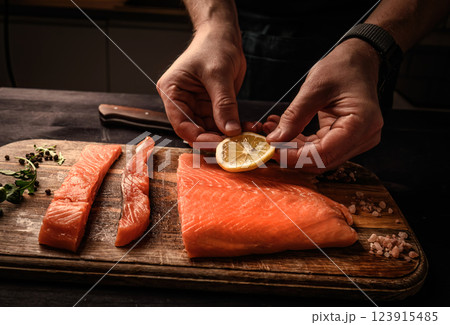 Chief cooking salmon red fish for healthy dinner with Omega-3 and vitamins Chief cooking salmon red fish for healthy dinner with Omega-3 and vitamins 123915485