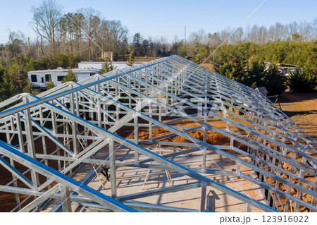 New metal beams structure is being constructed with clear view of trailer in background. New metal beams structure is being constructed with clear view of trailer in background. 123916022