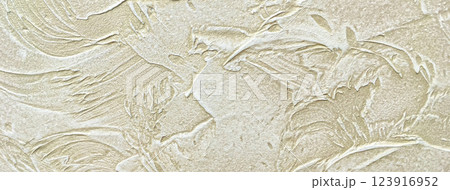 Texture decorative beige plaster background imitating the old peeling wall, macro. Obsolete sand cracked backdrop 123916952