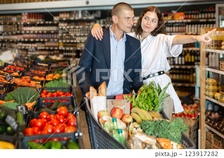 Woman pointing to something at supermarket Woman pointing to something at supermarket 123917282
