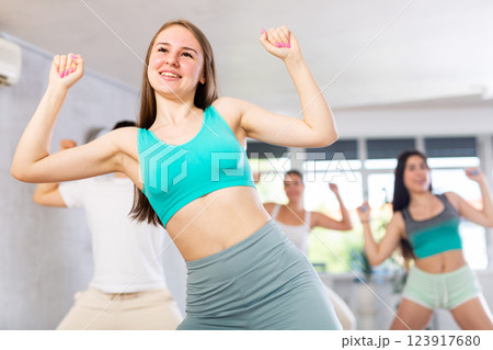 Teen girl krumper dancing with group of teenagers in studio 123917680