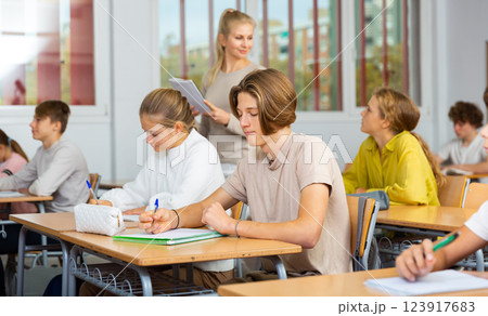 Group of school kids and teacher during lesson 123917683