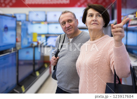 Portrait of a of mature age couple standing in the department with televisions 123917684