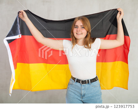 Attractive female student holding Germany flag 123917753