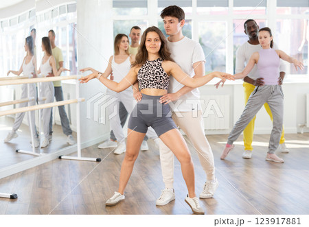 Man and young woman dancing waltz in couple during lesson at studio Man and young woman dancing waltz in couple during lesson at studio 123917881