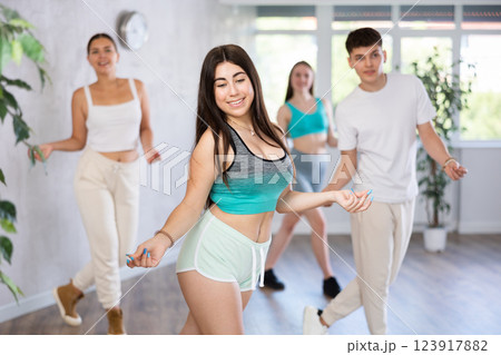 Active teenagers dancing modern dances in modern studio 123917882