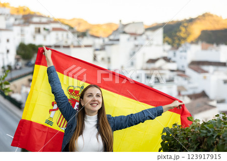 Hapy footbal fan woman waving the flag of Spain on street 123917915