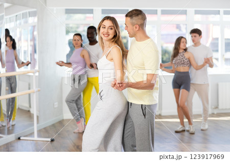 Young woman dances incendiary tango with man partner during choreography lesson Young woman dances incendiary tango with man partner during choreography lesson 123917969