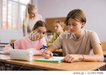 Teenage and young pupils doing tasks during lesson Teenage and young pupils doing tasks during lesson 123917996