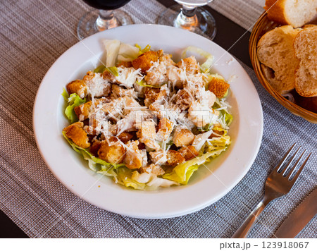 Chicken Caesar salad with tomatoes and cheese 123918067