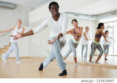 Young adult man exercising at dance class Young adult man exercising at dance class 123918697