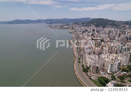 Coastal cityscape with modern buildings and serene water view 123919515