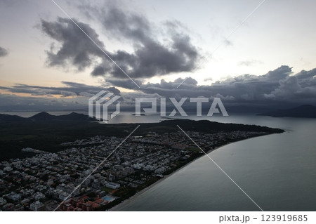 Coastal town facing stormy weather during twilight hours along the shoreline 123919685