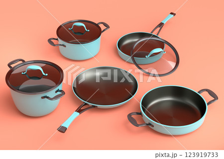 Set of flying stewpot, frying pan and chrome plated cookware on orange 123919733