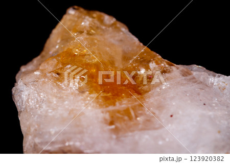 Macro mineral stone Citrine on black background 123920382