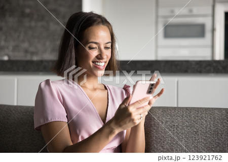 Smiling young woman enjoy chat with boyfriend on her smartphone Smiling young woman enjoy chat with boyfriend on her smartphone 123921762