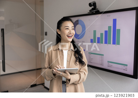 Happy young Asian manager working with tablet in office boardroom 123921903