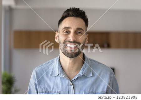 Head shot portrait young Hispanic man smile staring at camera Head shot portrait young Hispanic man smile staring at camera 123921908