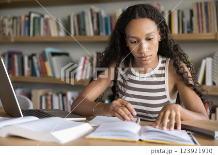 Focused African girl studying in college library 123921910