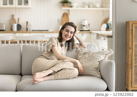 Happy gen z woman rest on sofa at home kitchen Happy gen z woman rest on sofa at home kitchen 123922002
