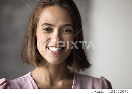 Pretty woman with warm and friendly smile looking at camera Pretty woman with warm and friendly smile looking at camera 123922043