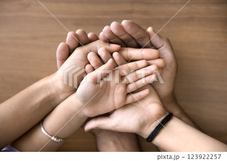 Mother, father and two kids stacked their palms together, closeup Mother, father and two kids stacked their palms together, closeup 123922257