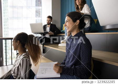 Diverse groupmates take part in educational class seated in auditorium Diverse groupmates take part in educational class seated in auditorium 123922285