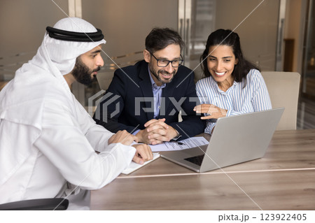Smiling European couple watching online presentation on laptop Smiling European couple watching online presentation on laptop 123922405