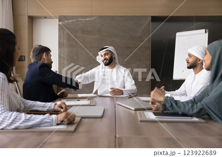 European businessman start negotiation with Muslim partners reach agreement, handshaking 123922689