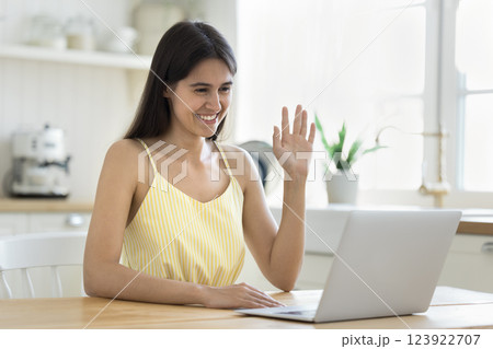 Smiling teen female remote student wave hello to notebook webcam 123922707