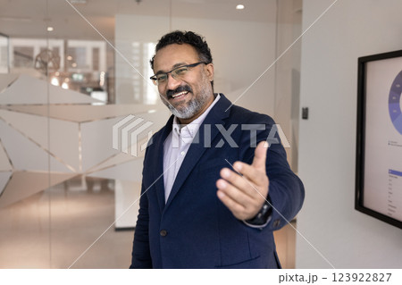 Happy mature Indian business leader man inviting to join team 123922827