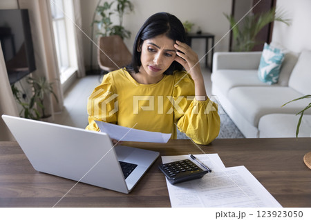 Young Indian woman feels stressed due to financial issues Young Indian woman feels stressed due to financial issues 123923050