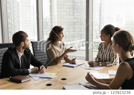 Group of multiethnic businesspeople communicate in conference room in office 123923236