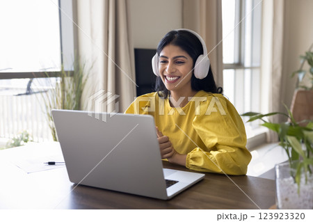 Indian woman listening audio course to improve foreign language knowledge 123923320