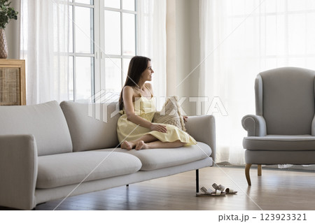 Happy young girl relax on couch in luxury living room Happy young girl relax on couch in luxury living room 123923321