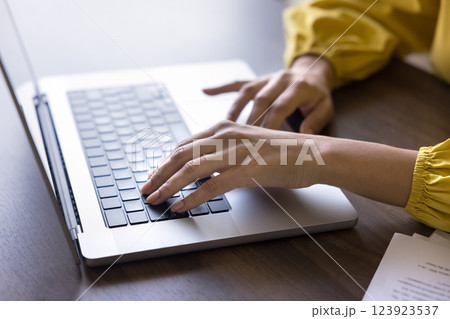 Woman working remotely using laptop, close up shot Woman working remotely using laptop, close up shot 123923537