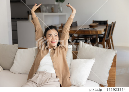 Cheerful beautiful awaking young Asian woman enjoying calm leisure time Cheerful beautiful awaking young Asian woman enjoying calm leisure time 123923554