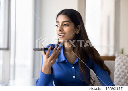 Pretty Indian woman lead personal talk on speakerphone 123923574